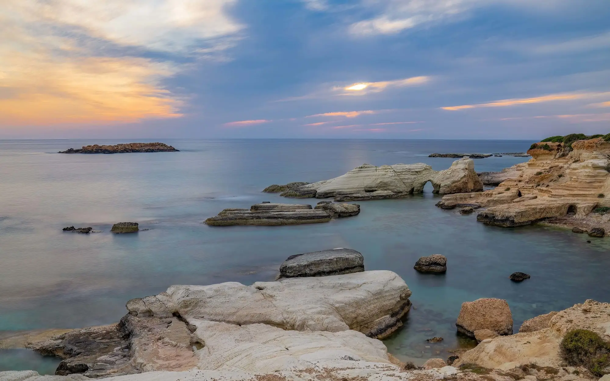 Rocky Cyprus coastline under an evening sky